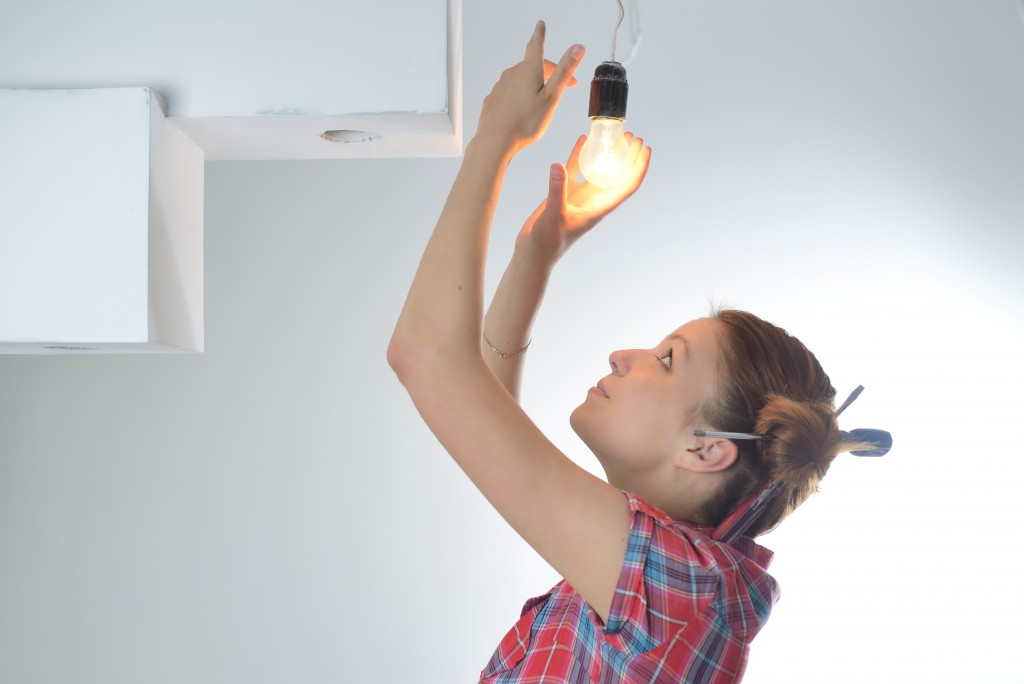 woman changing lightbulbs