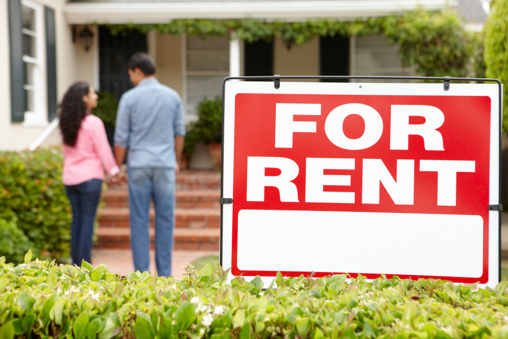 Couple standing outside home for rent