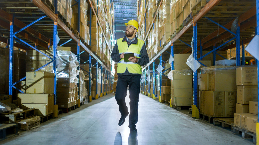 man checking quality of warehouse stocks