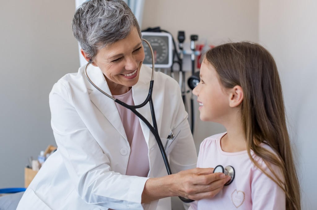 Doctor uses stethoscope on child