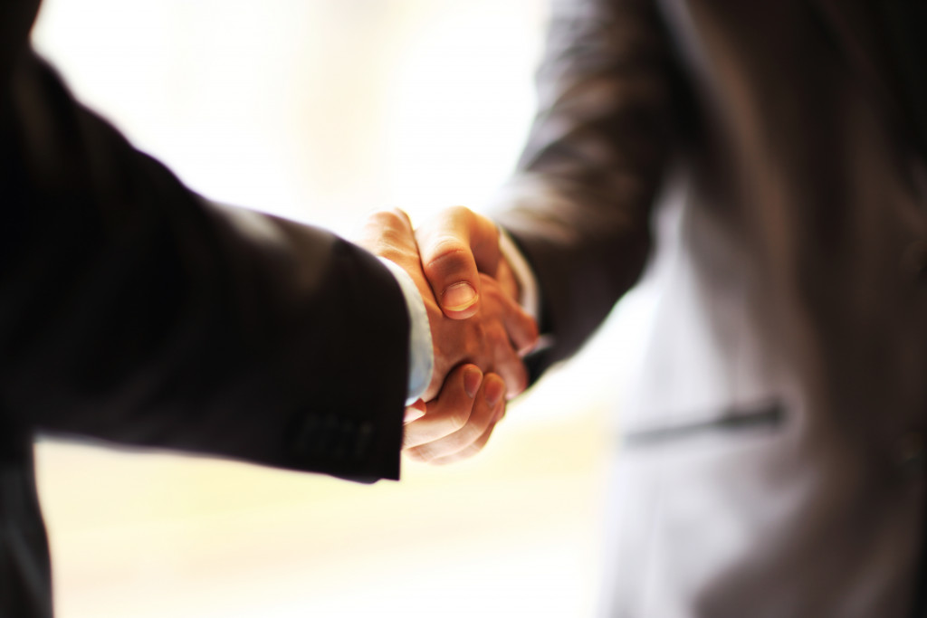 two men shaking hands in the office