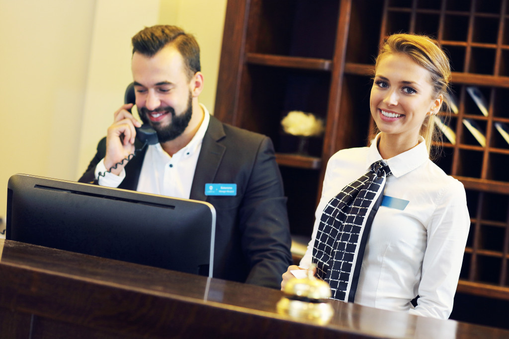 Two receptionists behind hotel desk