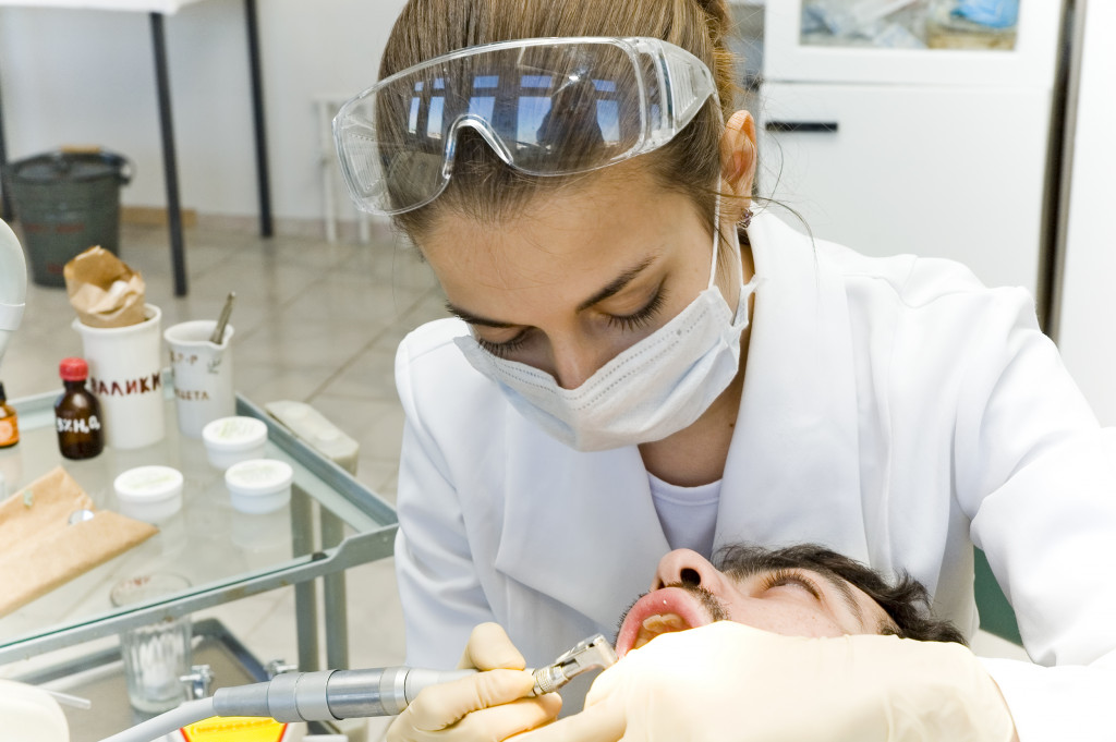 photo of a man having his teeth cleaned inside a dental clinic