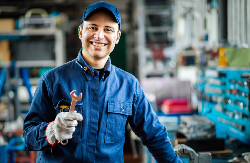 An experienced mechanic holding a wrench