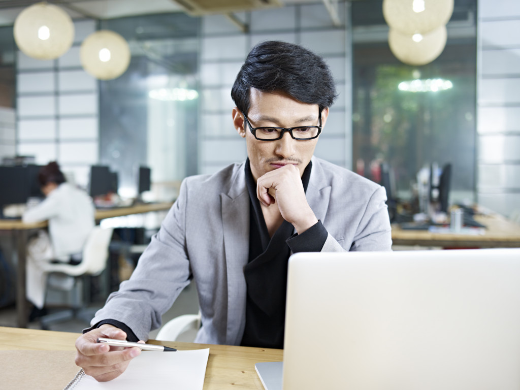 business man researching and taking notes