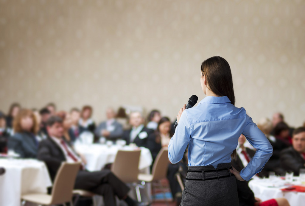 A speaker in front of the crowd at an office event