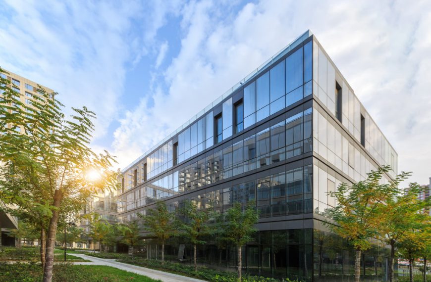 large modern glass office building in suburban neighborhood