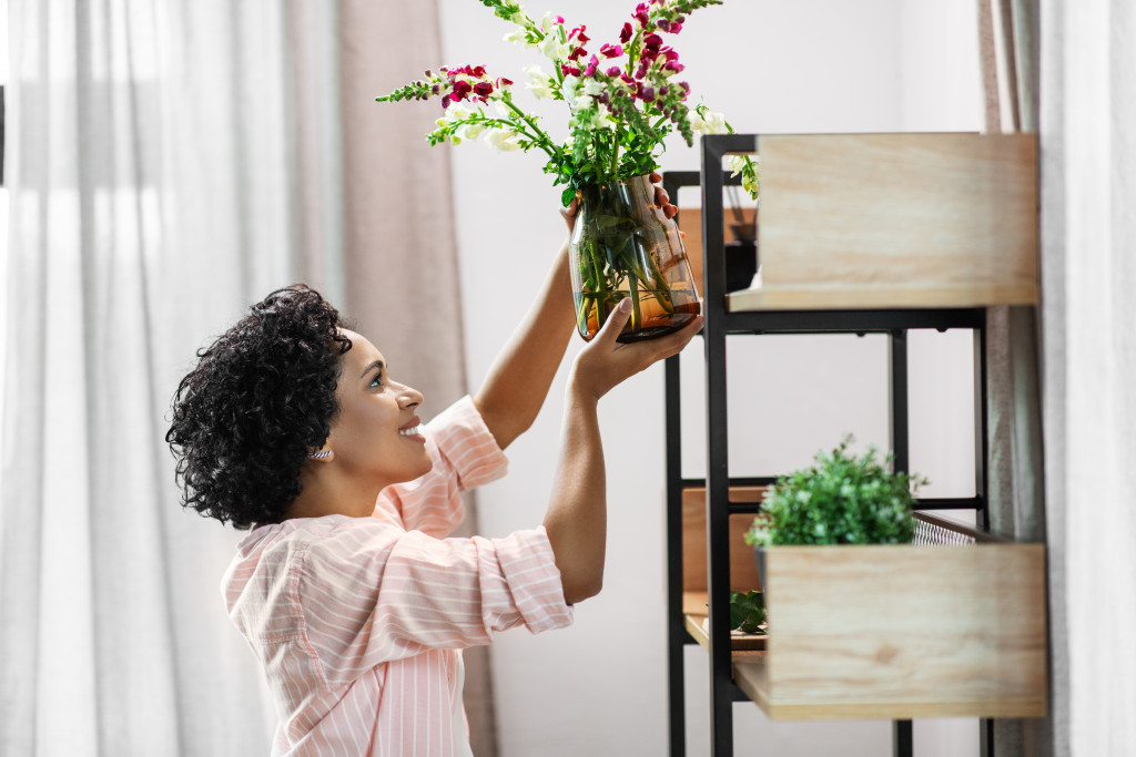 woman arranging home decor