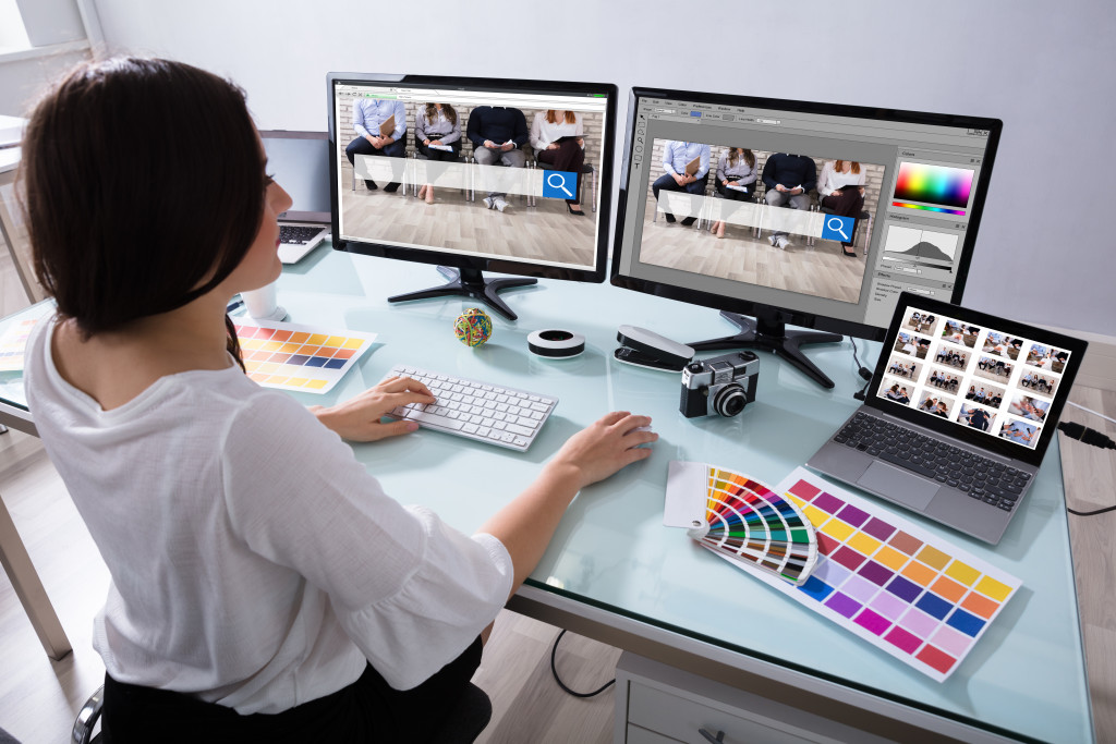 Graphic artist working on her table while at the office.