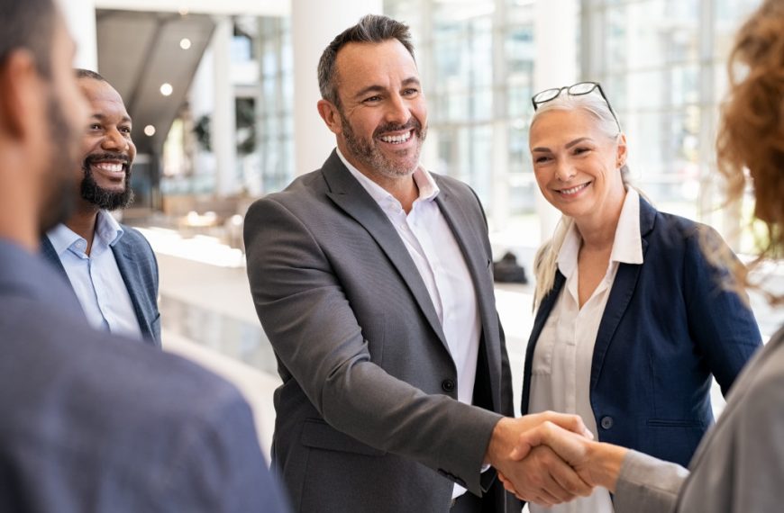 a professional businessman shaking hands with a business woman on a meeting