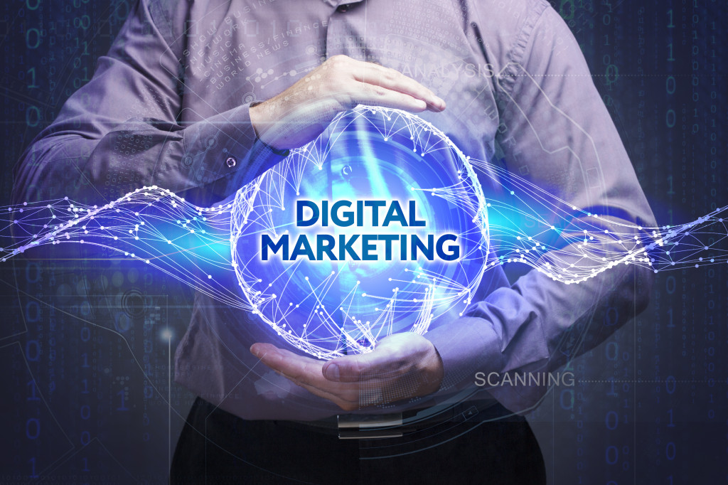 Visual representation of digital marketing in a ball with a person holding it.