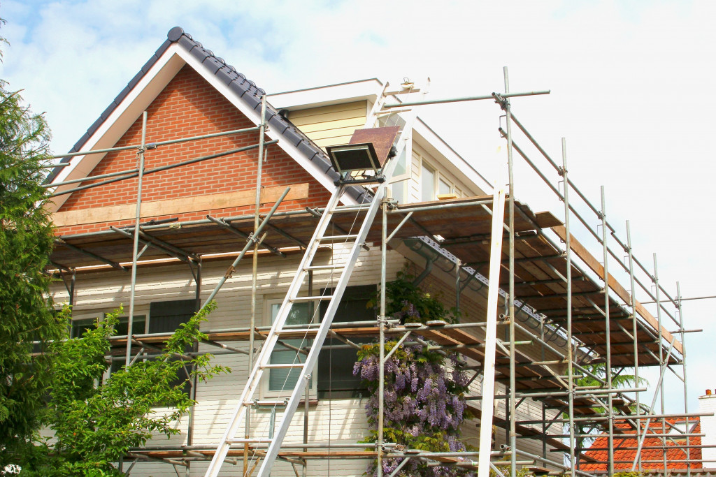 Renovation of the exterior of a house with construction materials outside.