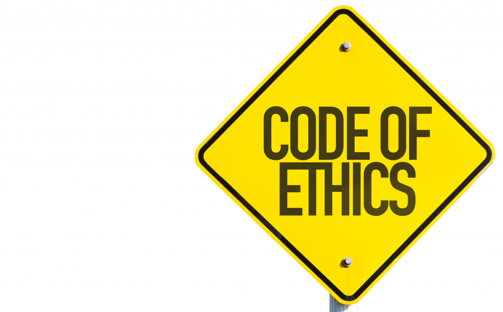 A yellow CODE OF ETHICS sign