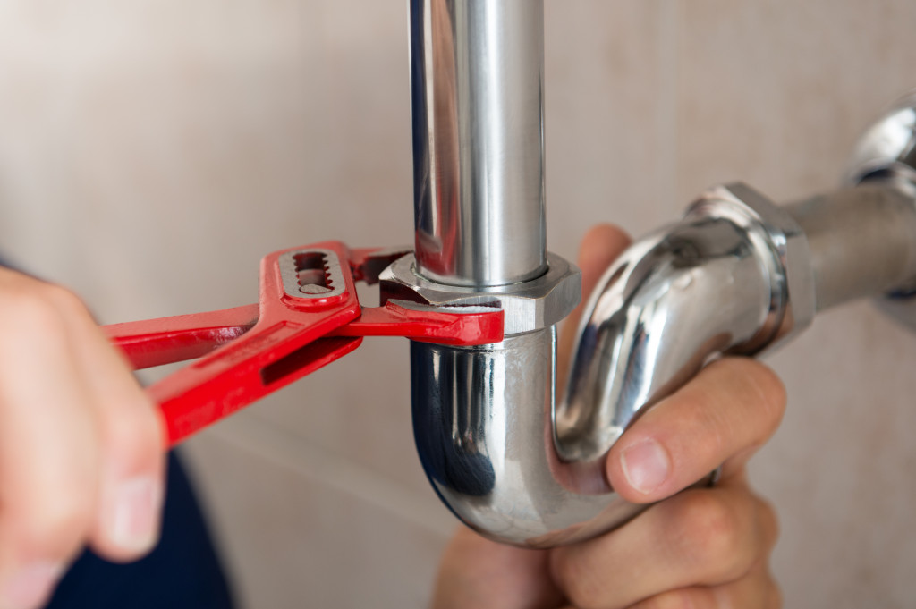 A plumber fixing a sink pipe