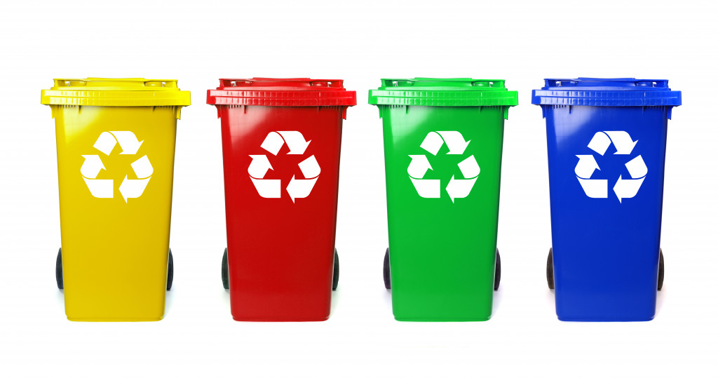 Four colorful recycling bins