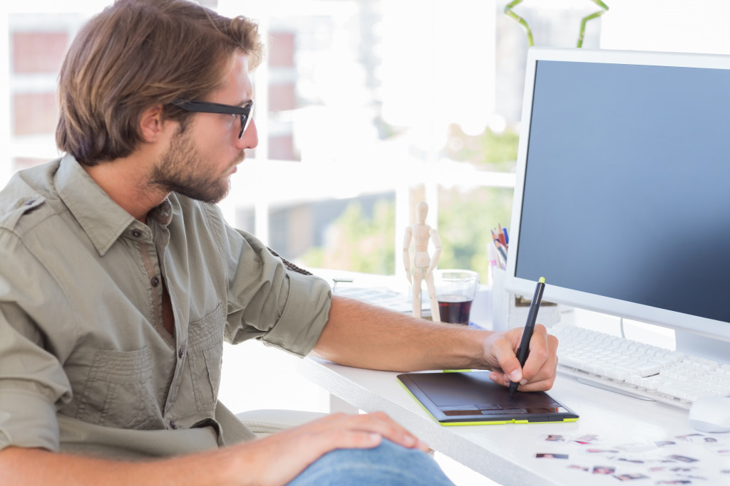 an artist drawing on a virtual tablet creating a design