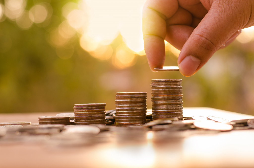 male hand stacking coins