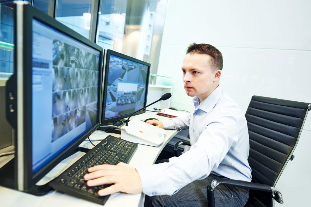 a security guard overseeing CCTV cameras