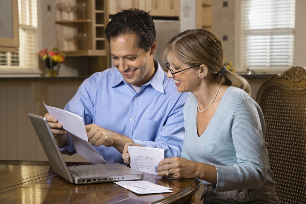 Young couple checking their finances using a computer.