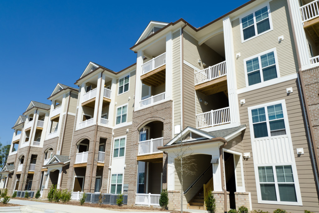 New multi-level apartment building in a suburban area.