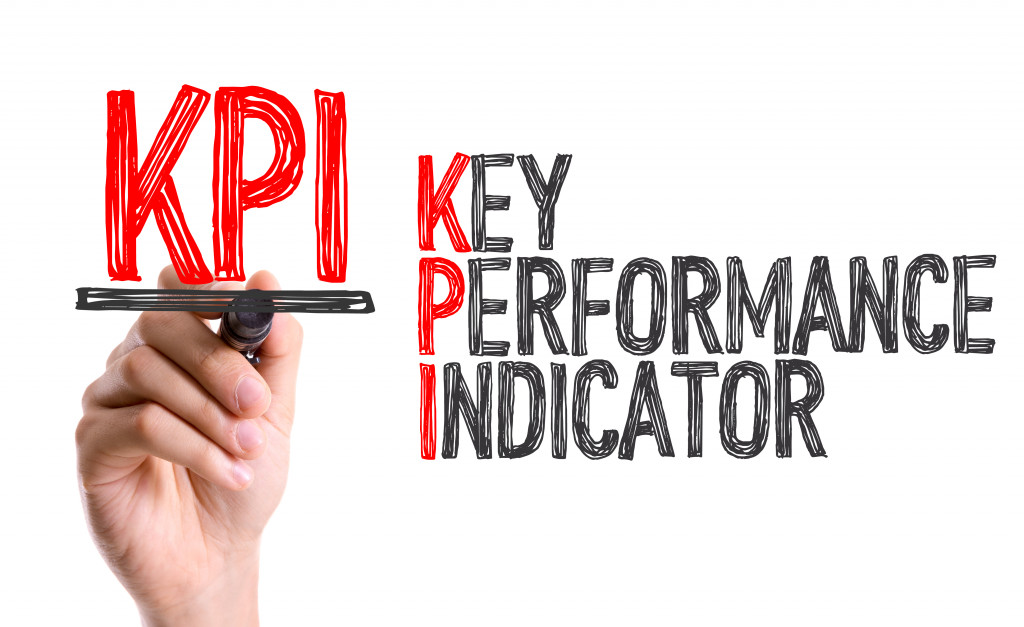 A hand writing KPI with a marker