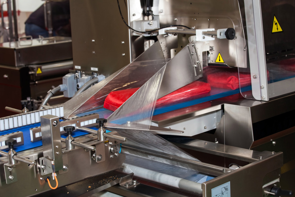 Vacuum packaging machine inside a food production facility.