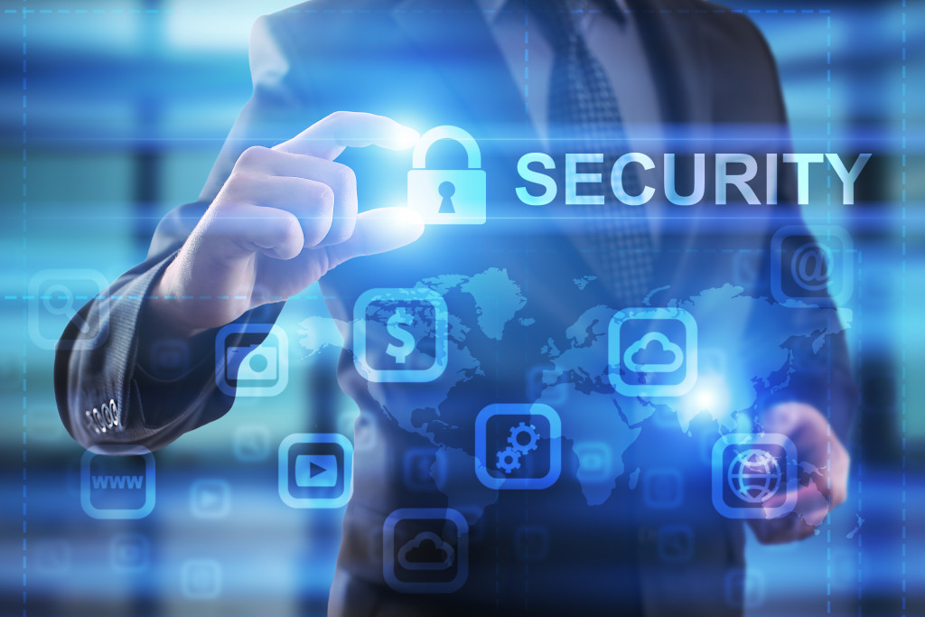 A businessman holding a padlock logo with the word SECURITY