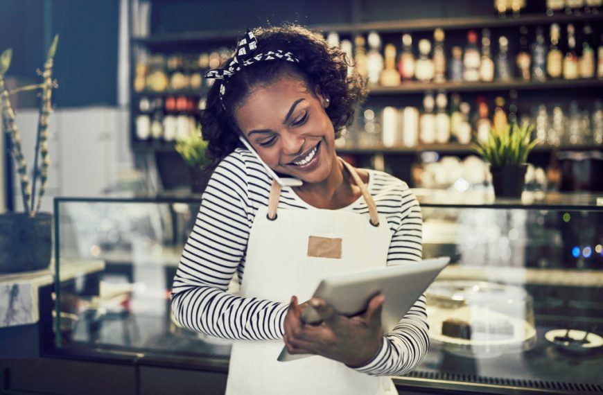 colored woman smiling while on the phone