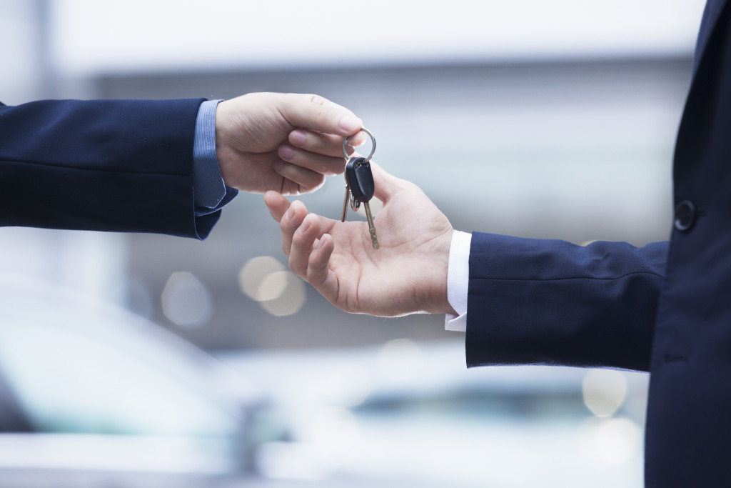 Car ownership being given keys