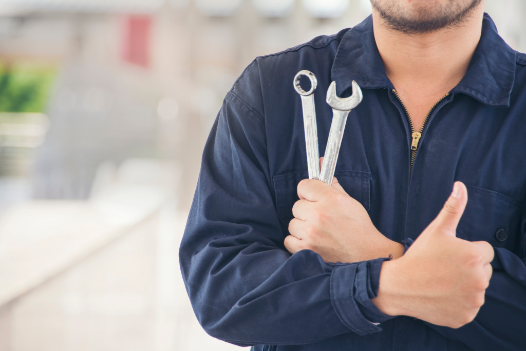 Auto mechanic with thumbs up