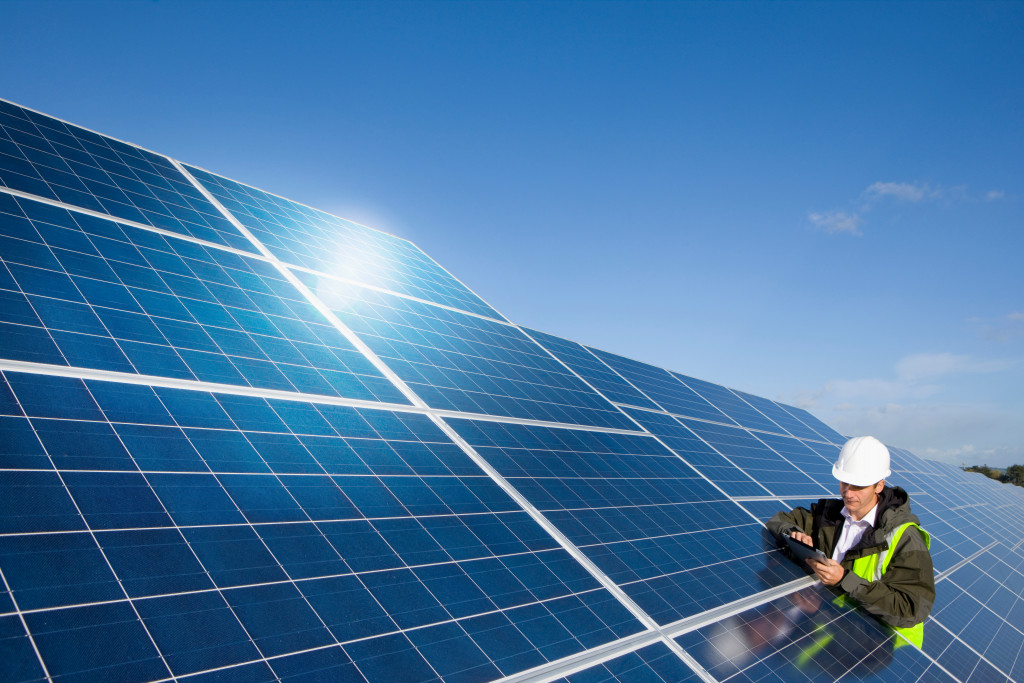 An engineer inspecting a solar panel