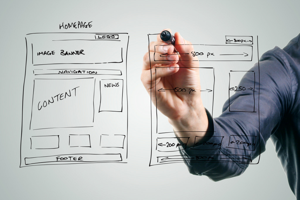 businessman writing website design in a whiteboard