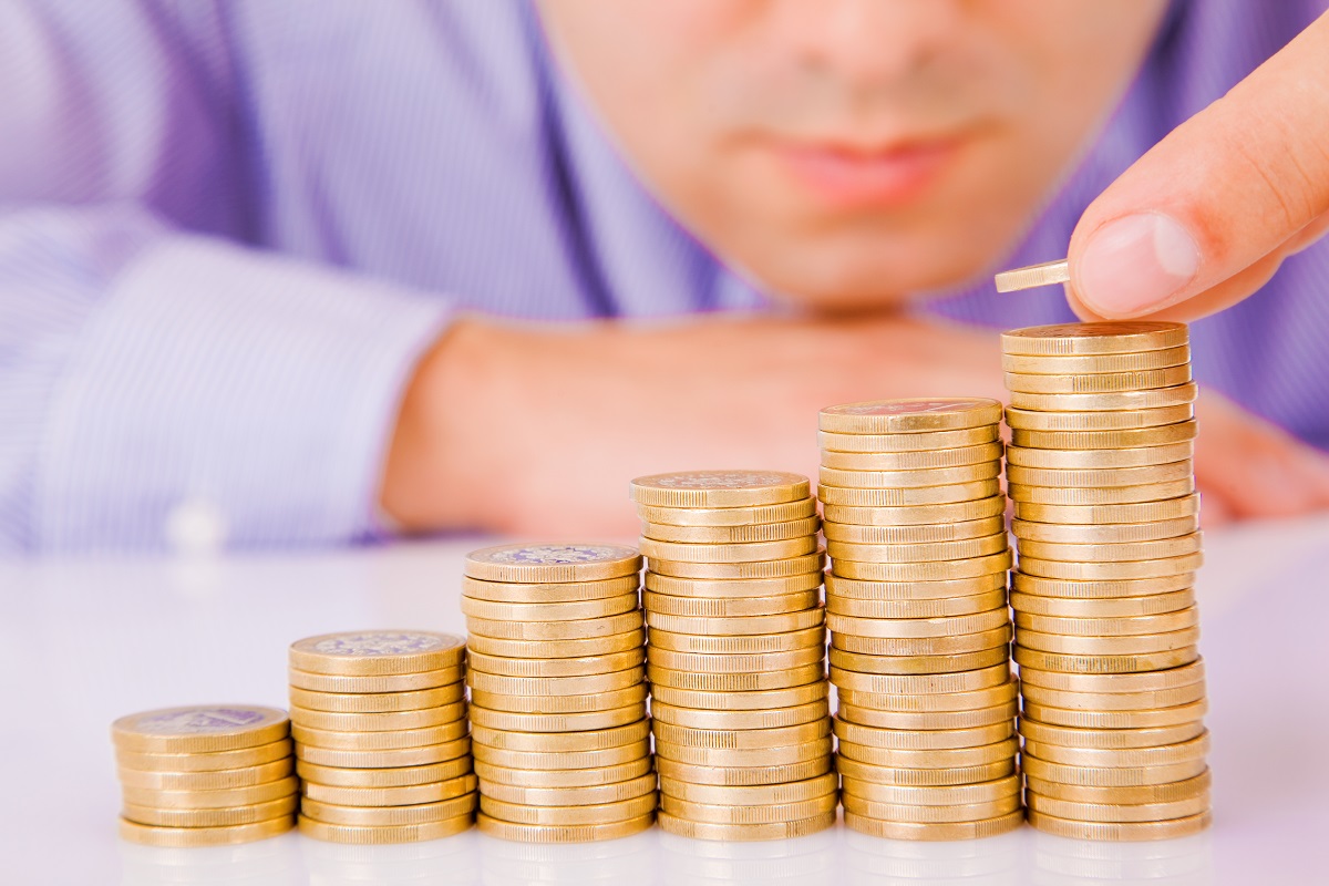 A man stacking coins